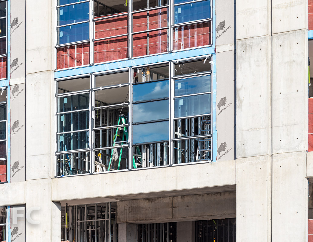 Close-up of the window installation underway on the south façade.