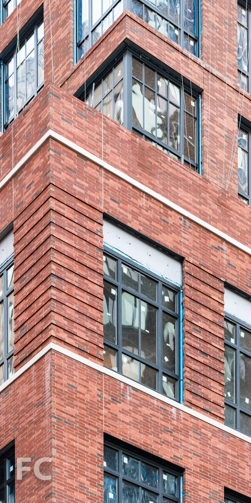 Close-up of the brick and glass facade at the northwest corner.