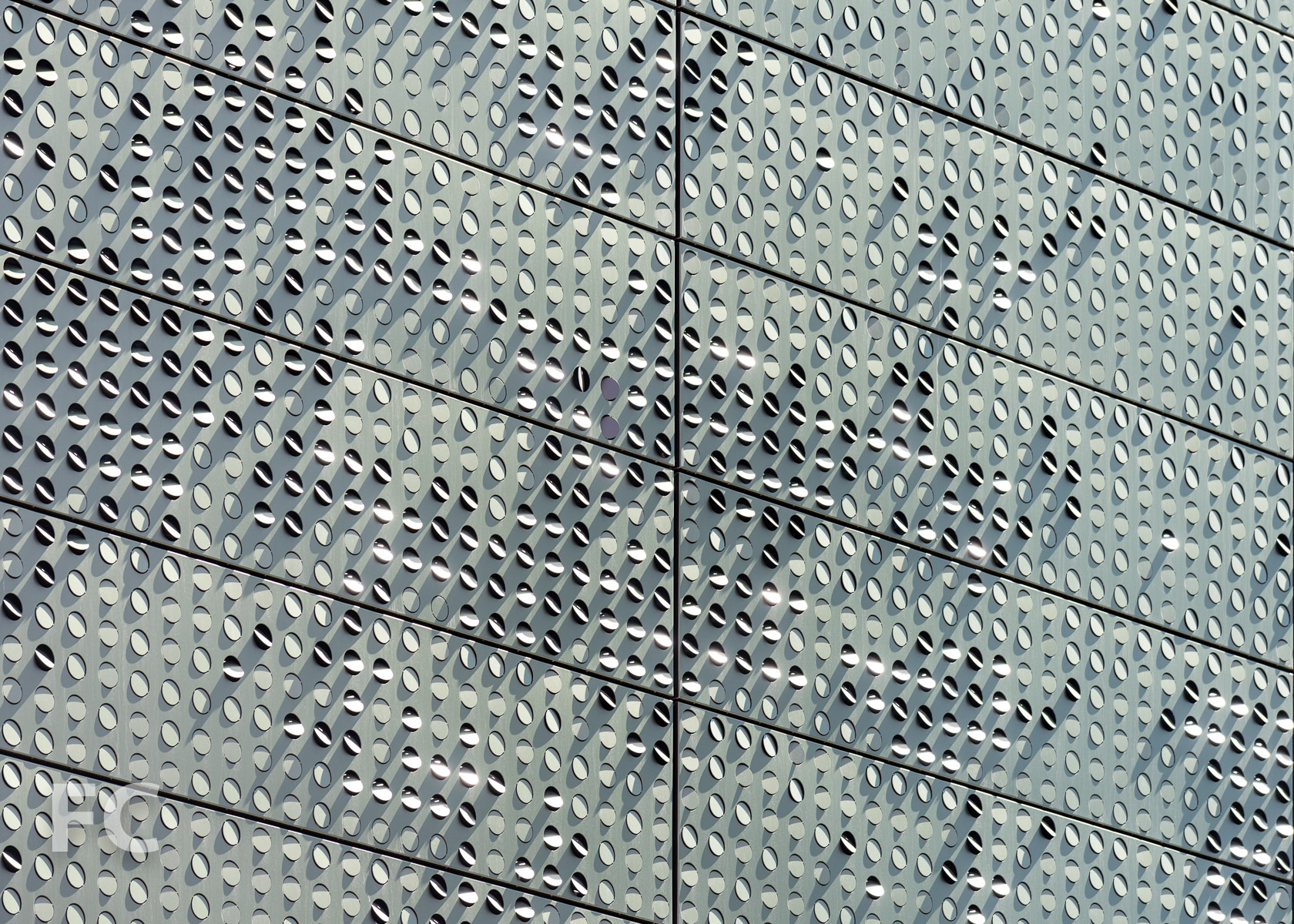 Close-up of the perforated metal panel façade of The Bloomberg Center.