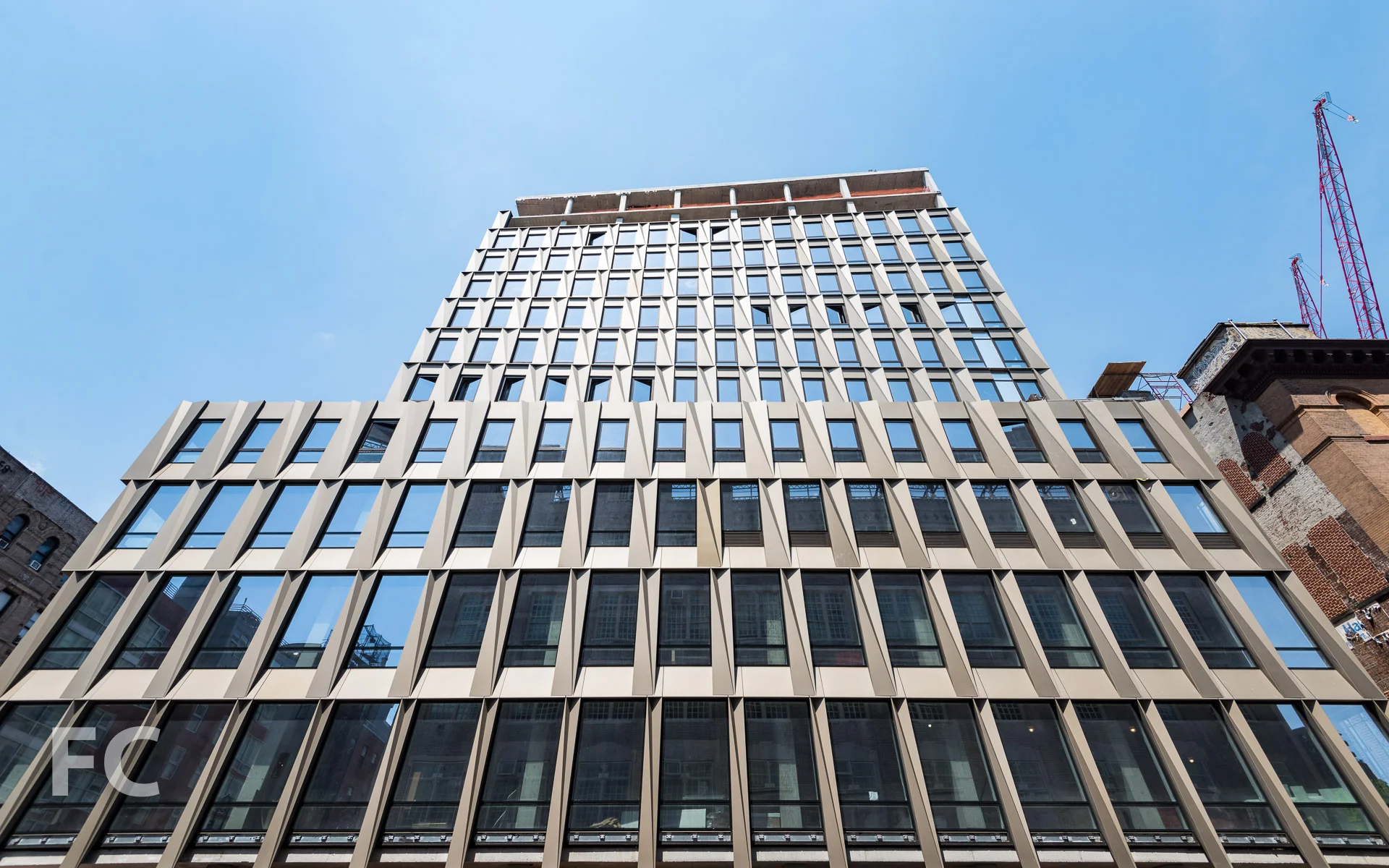 Looking up at the south facade from Broome Street.