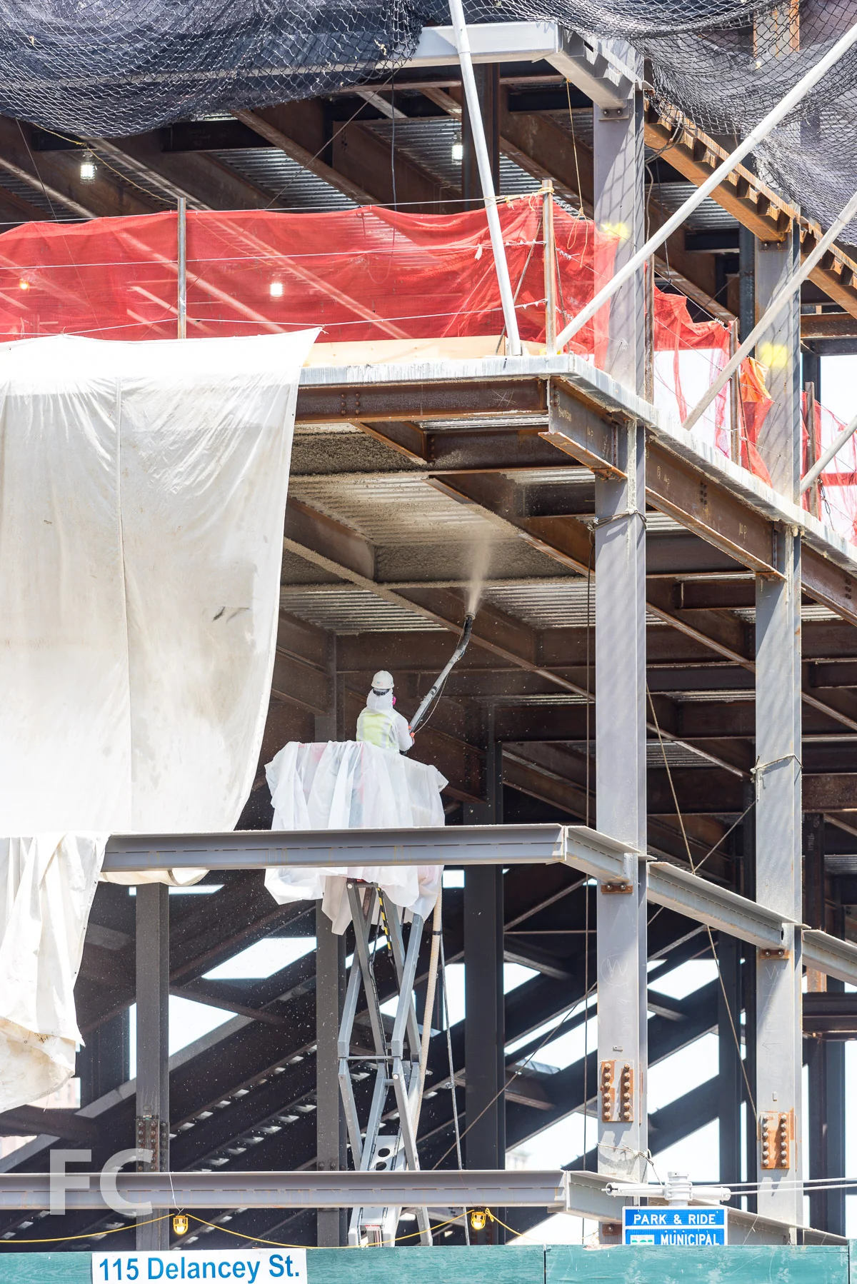 Fireproofing the steel for the Essex Street Market space.