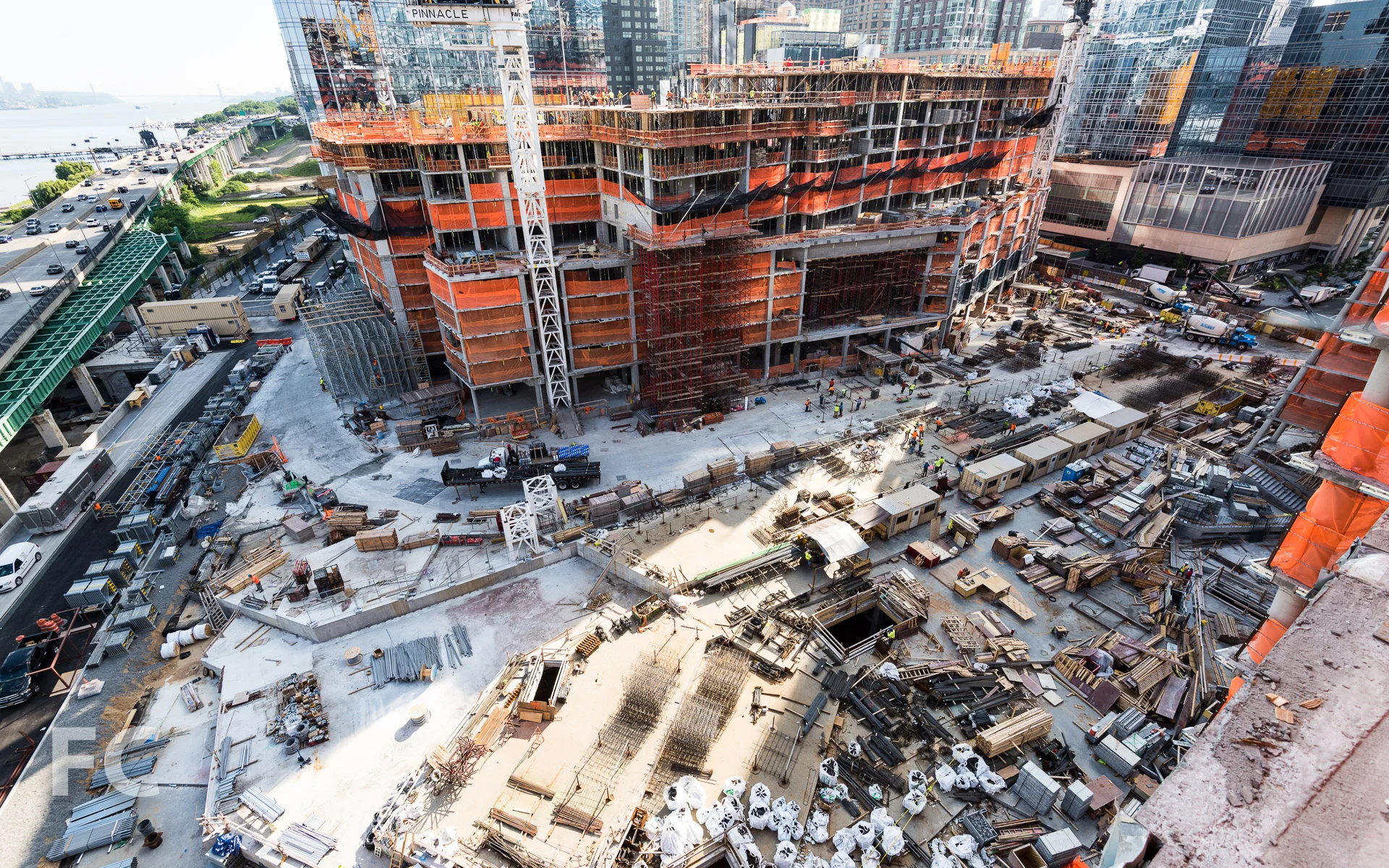 The logistics of a three-tower construction site atop the future open space.