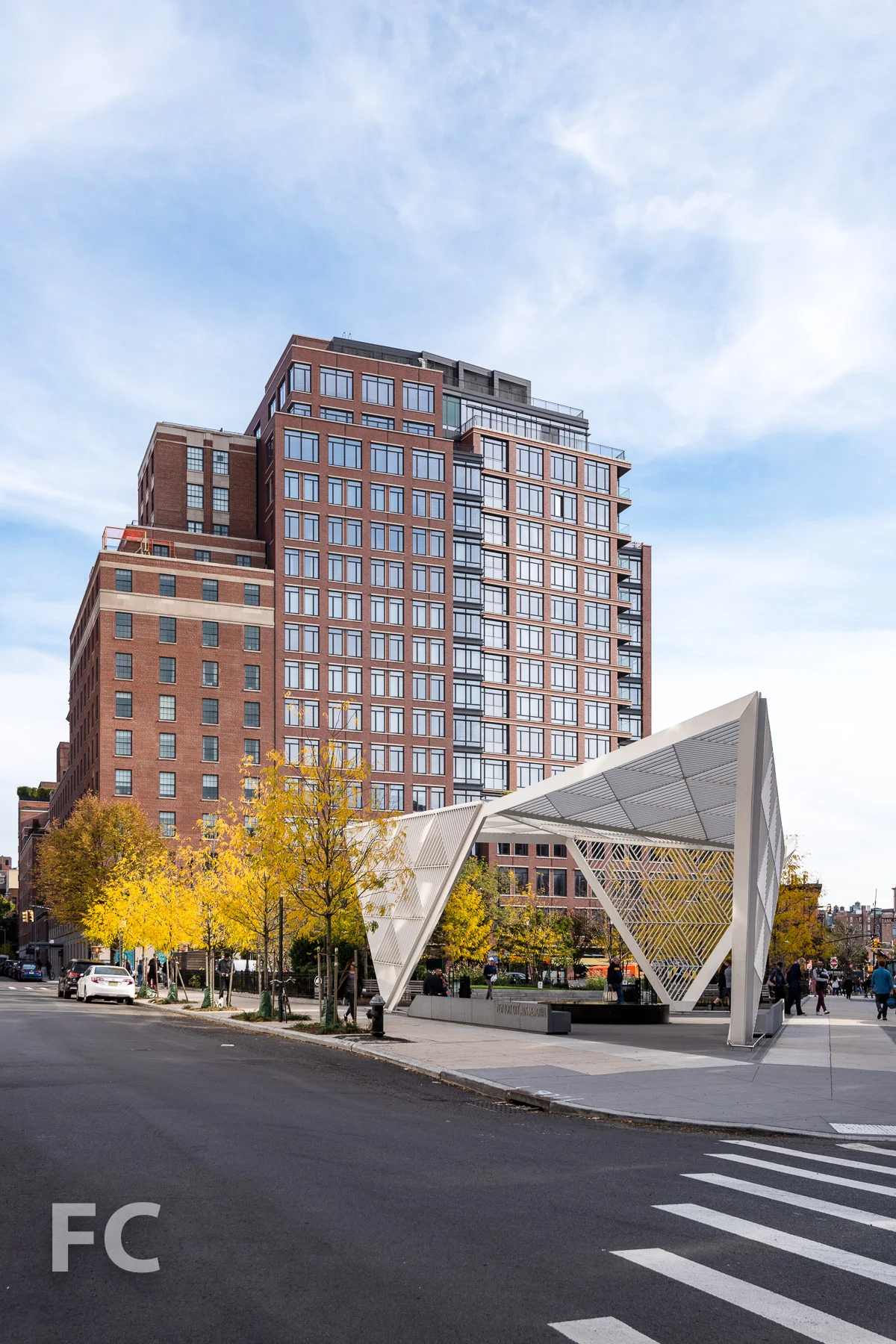 West facade of 160 West 12th Street (left) and 155 West 11th Street (right) with the New York City AIDS Memorial and St. Vincent's Triangle Park in the foreground.