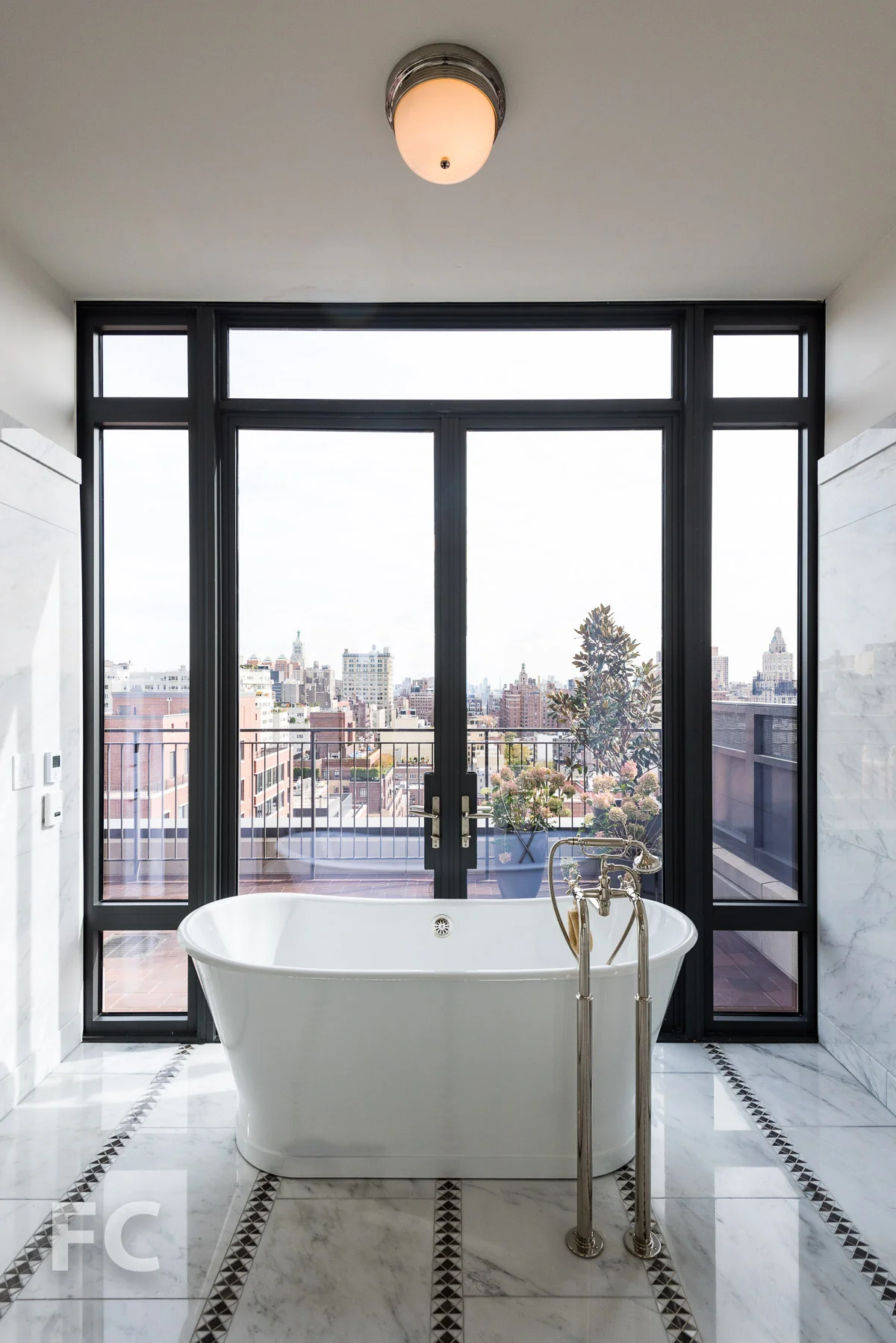 Master bath with a terrace and east facing skyline view.