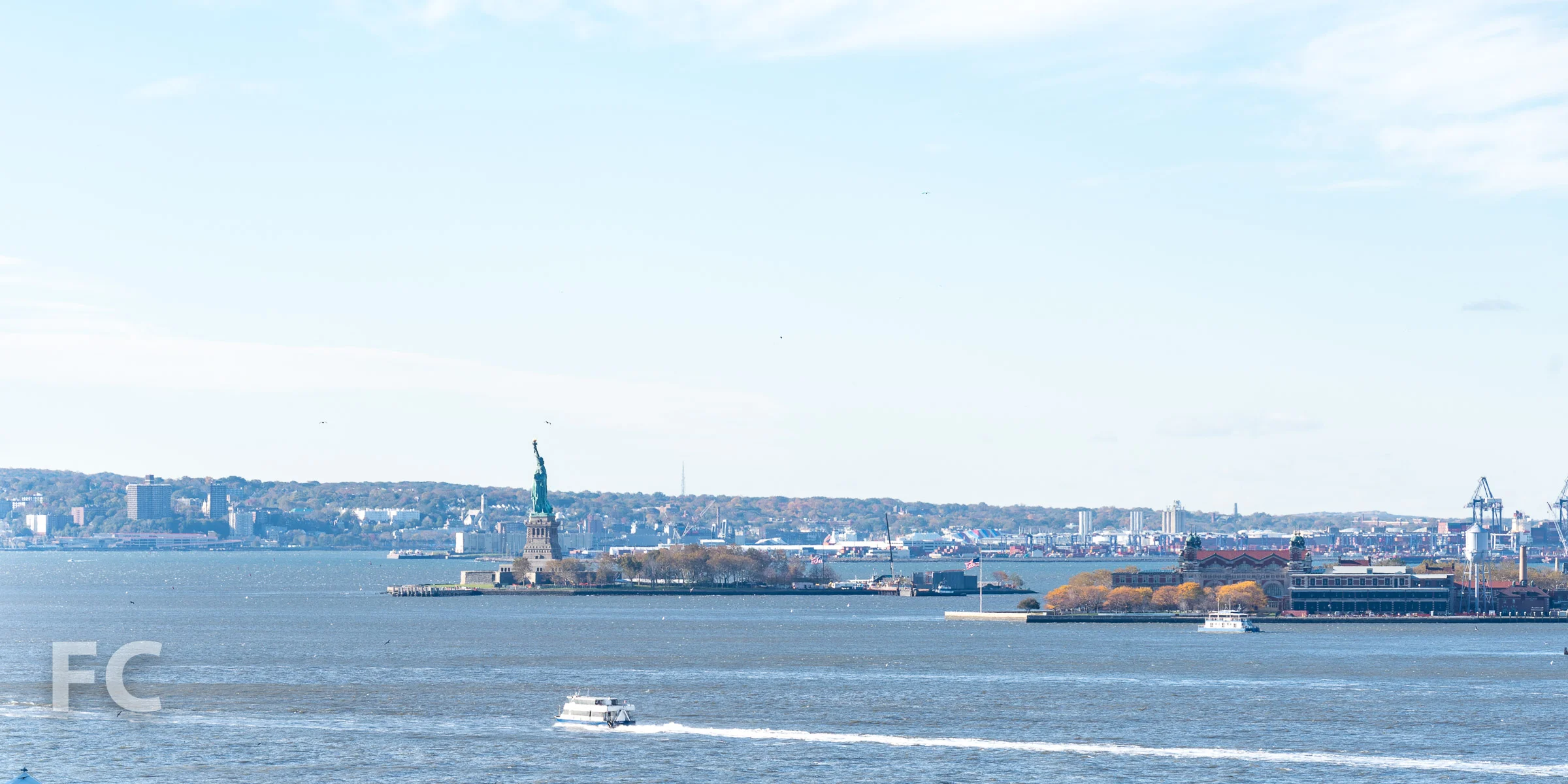 View southwest from the rooftop terrace towards the Statue of Liberty.