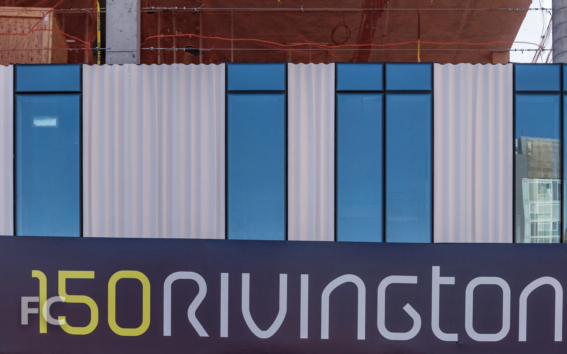 Close-up of the glass and custom cast curtain wall panels on the west facade.