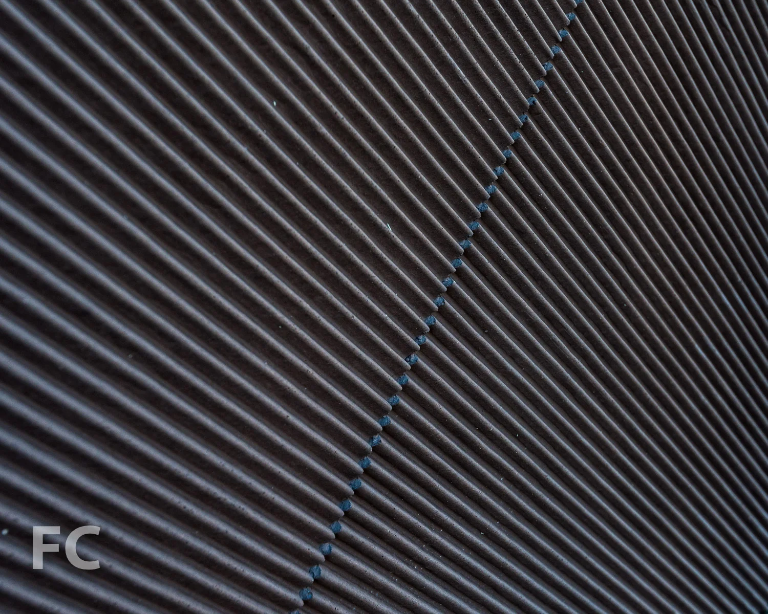 Close-up of the textured concrete facade panel.