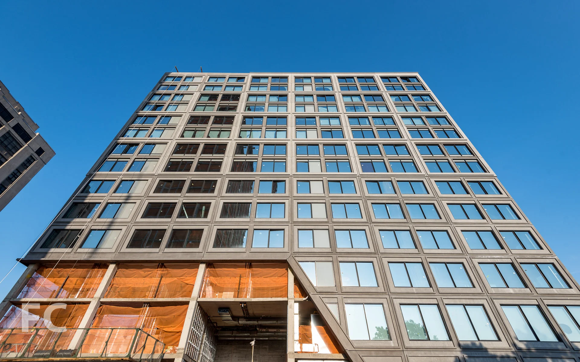 Looking up at the west facade of 15 Bridge Park Drive.