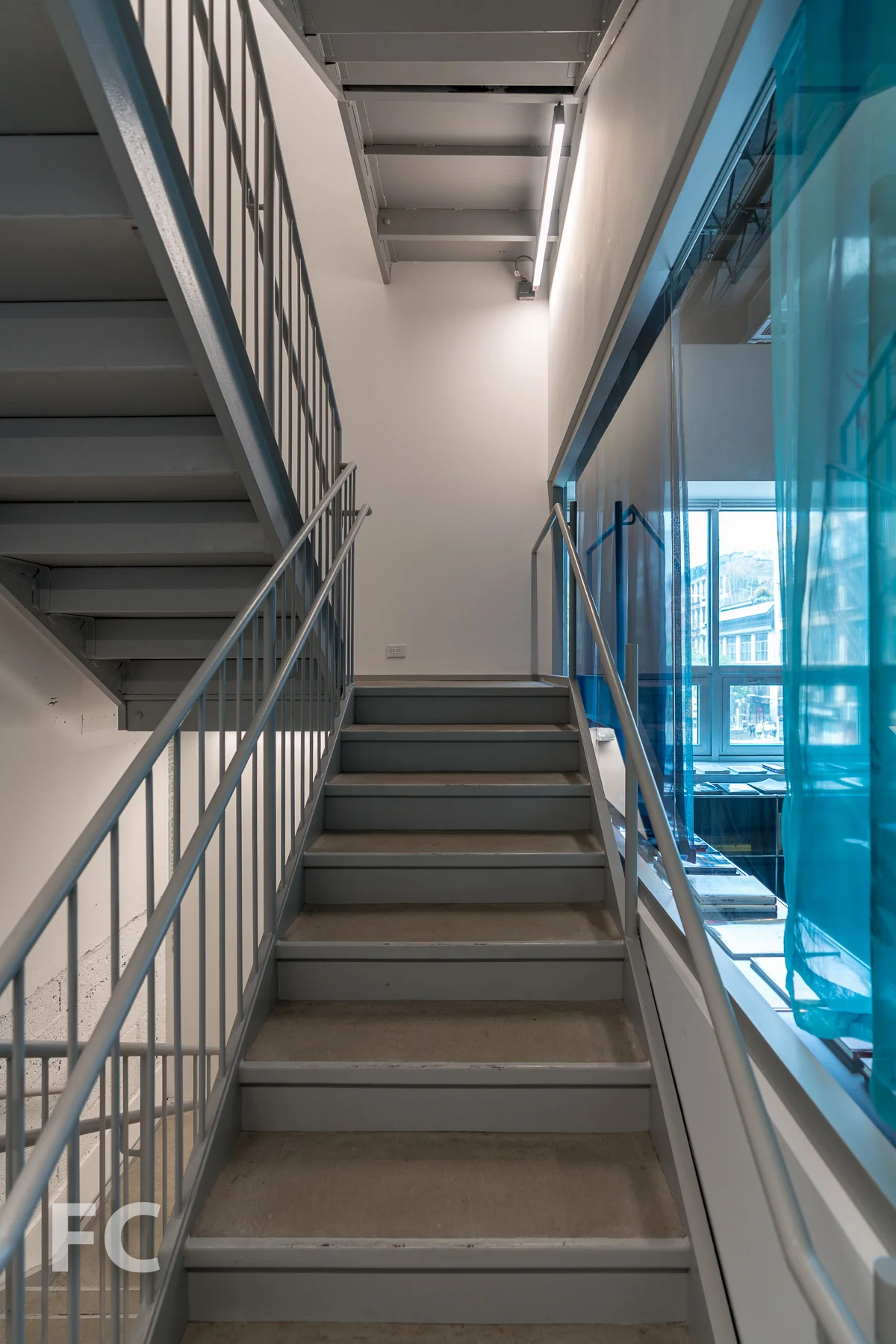 Stairwell with window looking onto the reading room.