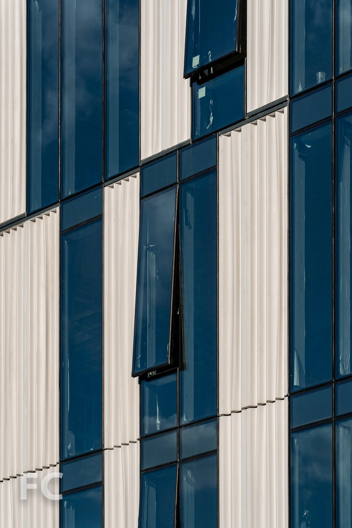 Close-up of the glass and custom cast curtain wall panels on the west facade.