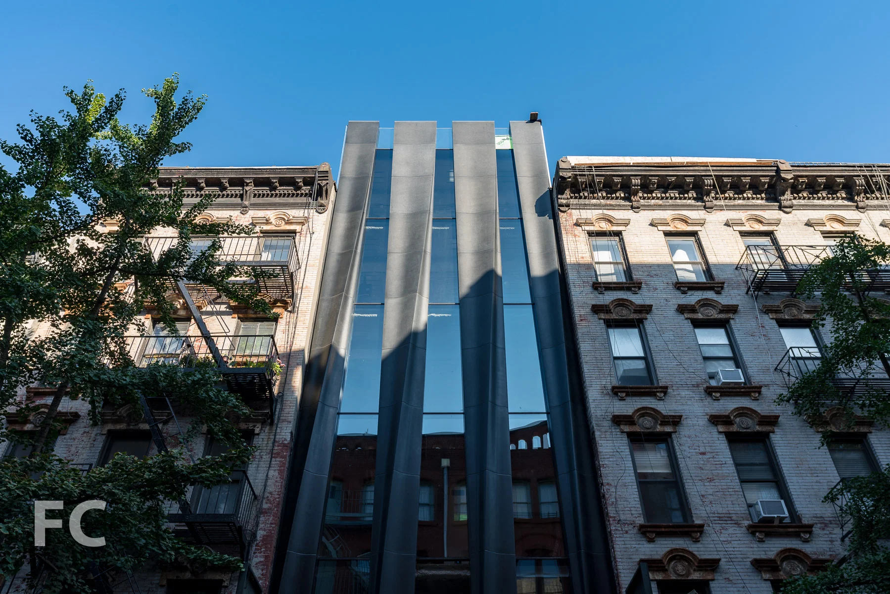 Looking up at the east facade on Mott Street.