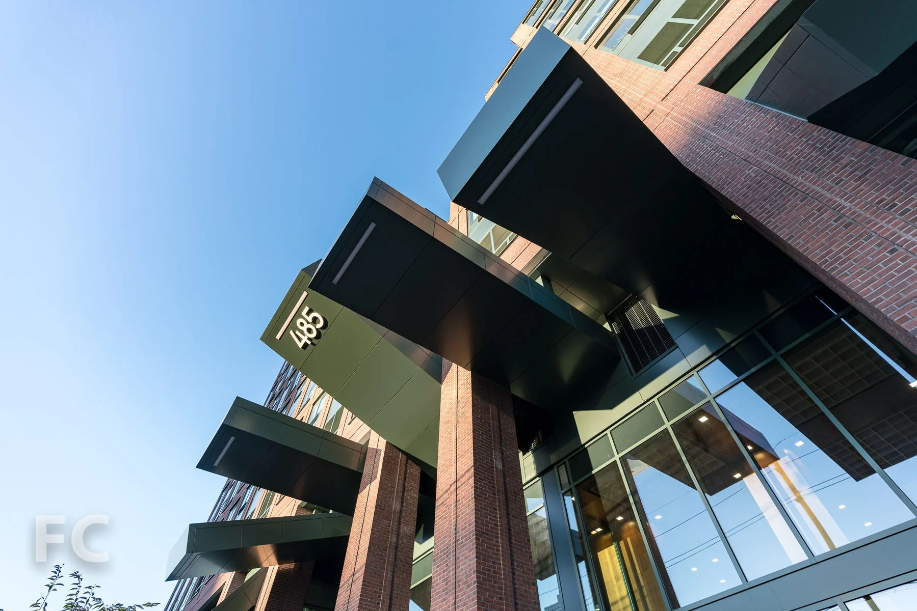 Looking up at the residential entry canopy at the east facade.