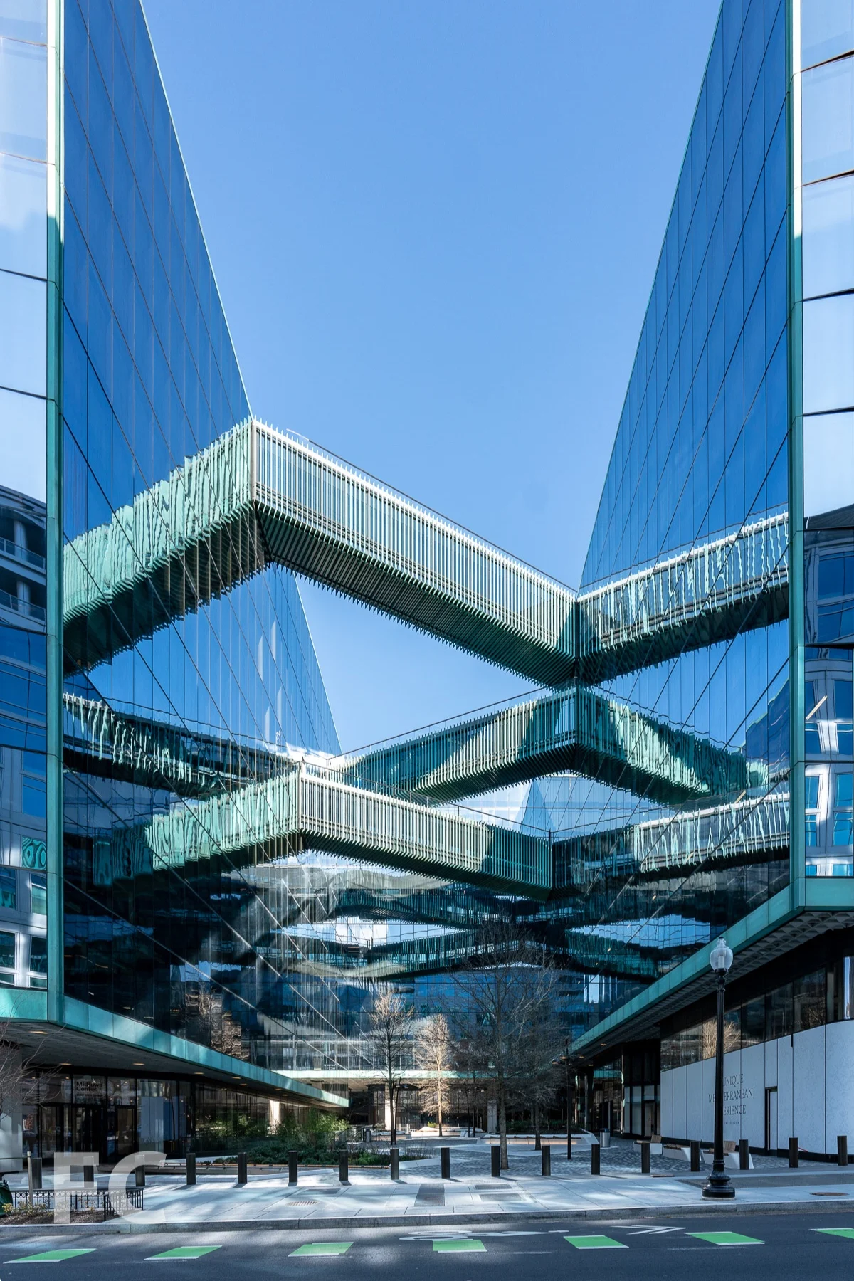 Criss crossing pedestrian bridges above the public plaza.