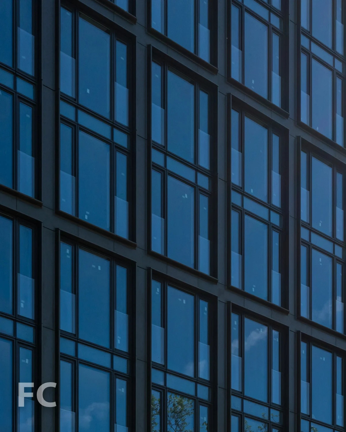 Close-up of the lower facade with glass railing at the operable windows to allow residents to fully open their windows.