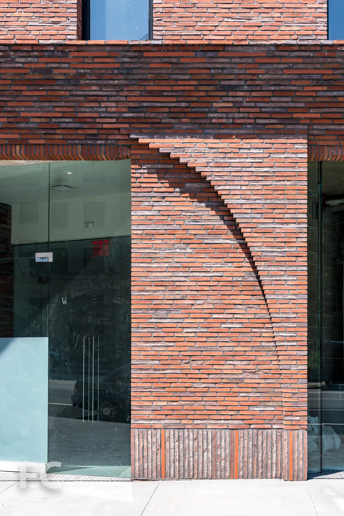 Close-up of the brick detailing at the ground floor storefront.