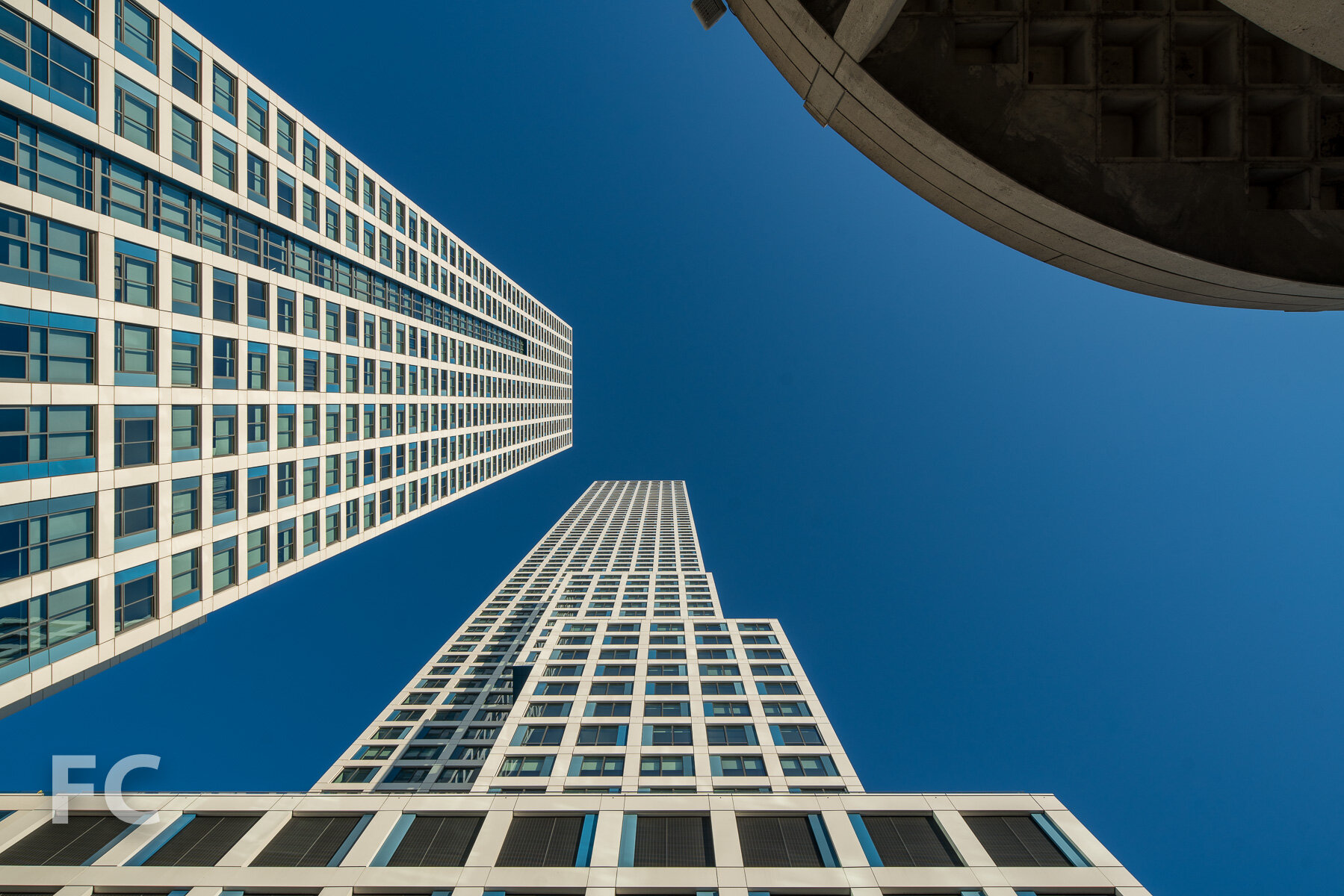 Looking up at the south facade of phase one (left) and the west facade of phase two (center).