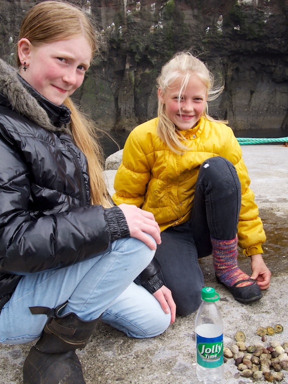 Kids playing at the harbour in Mykines, Faroe Islands