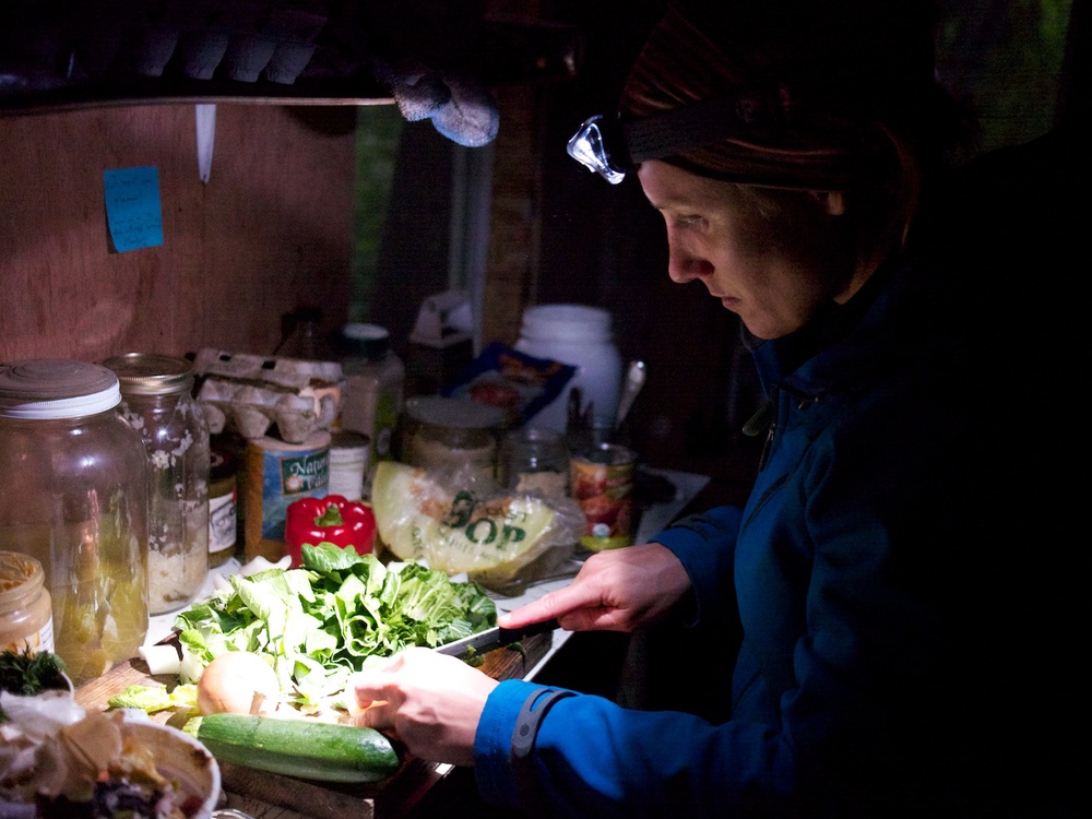 Emily preparing soup by head torch.