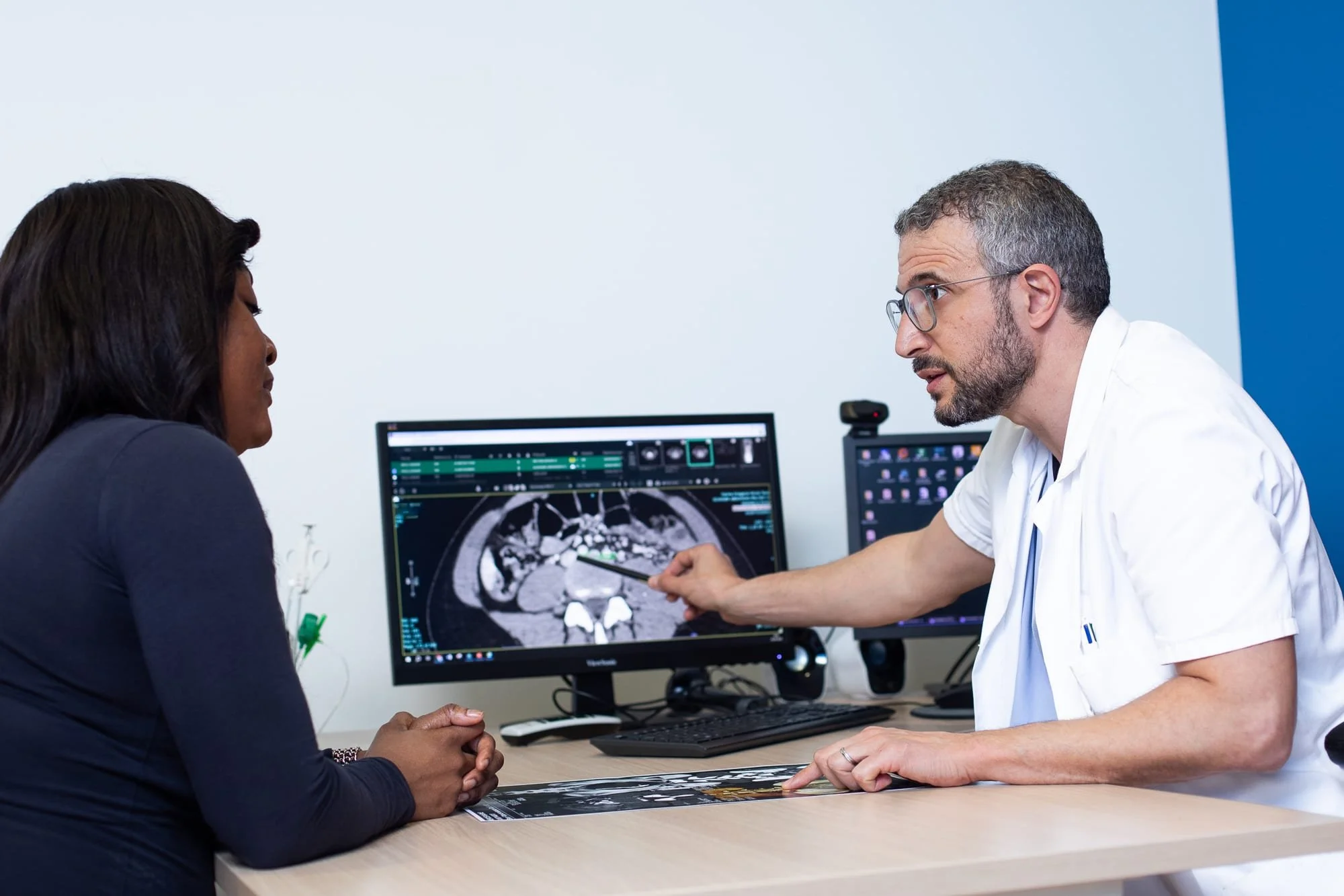 Reportage photo médical, radiologue expliquant un examen d’imagerie médicale à une patiente.