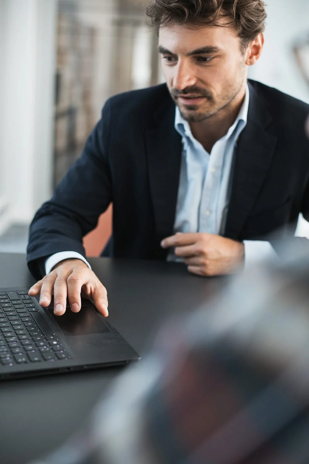 photo de détail d'une main sur un ordinateur pour illustrer les métiers d'une entreprise