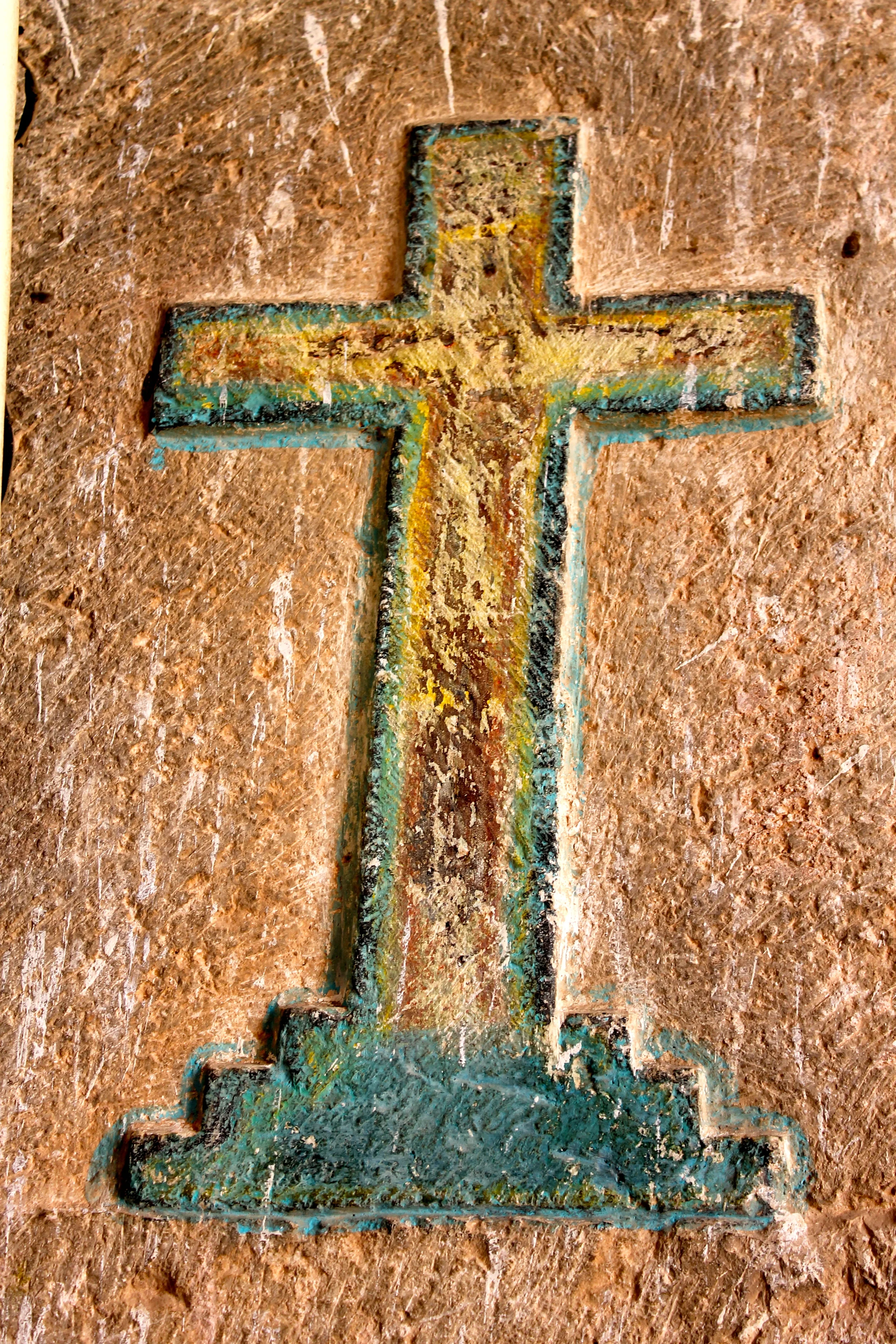 Wooden cross in stucco on a church wall in Mama (that's the name of the town, really)