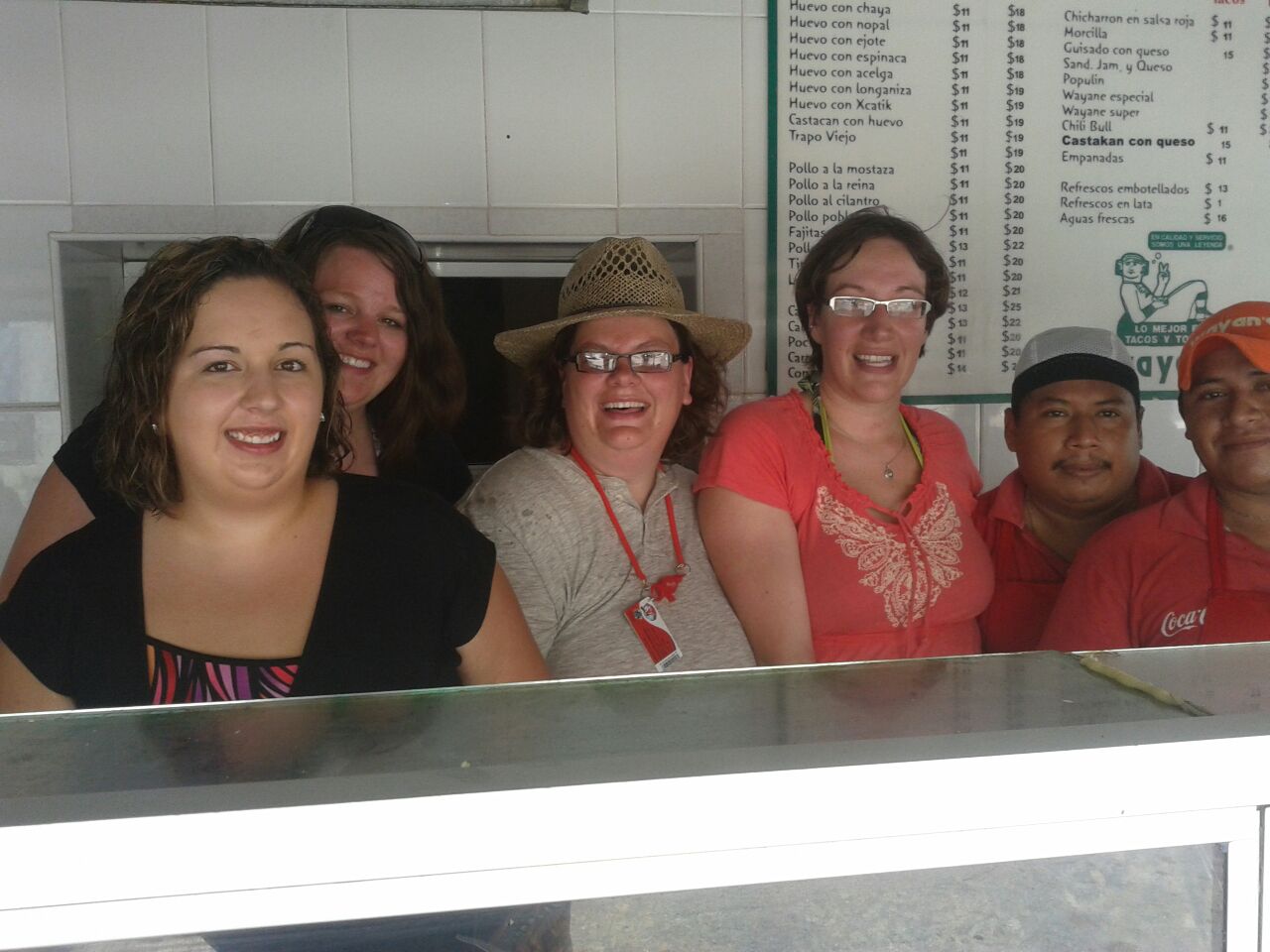 Here is the happy group INSIDE the taco kitchen with some of the staff!