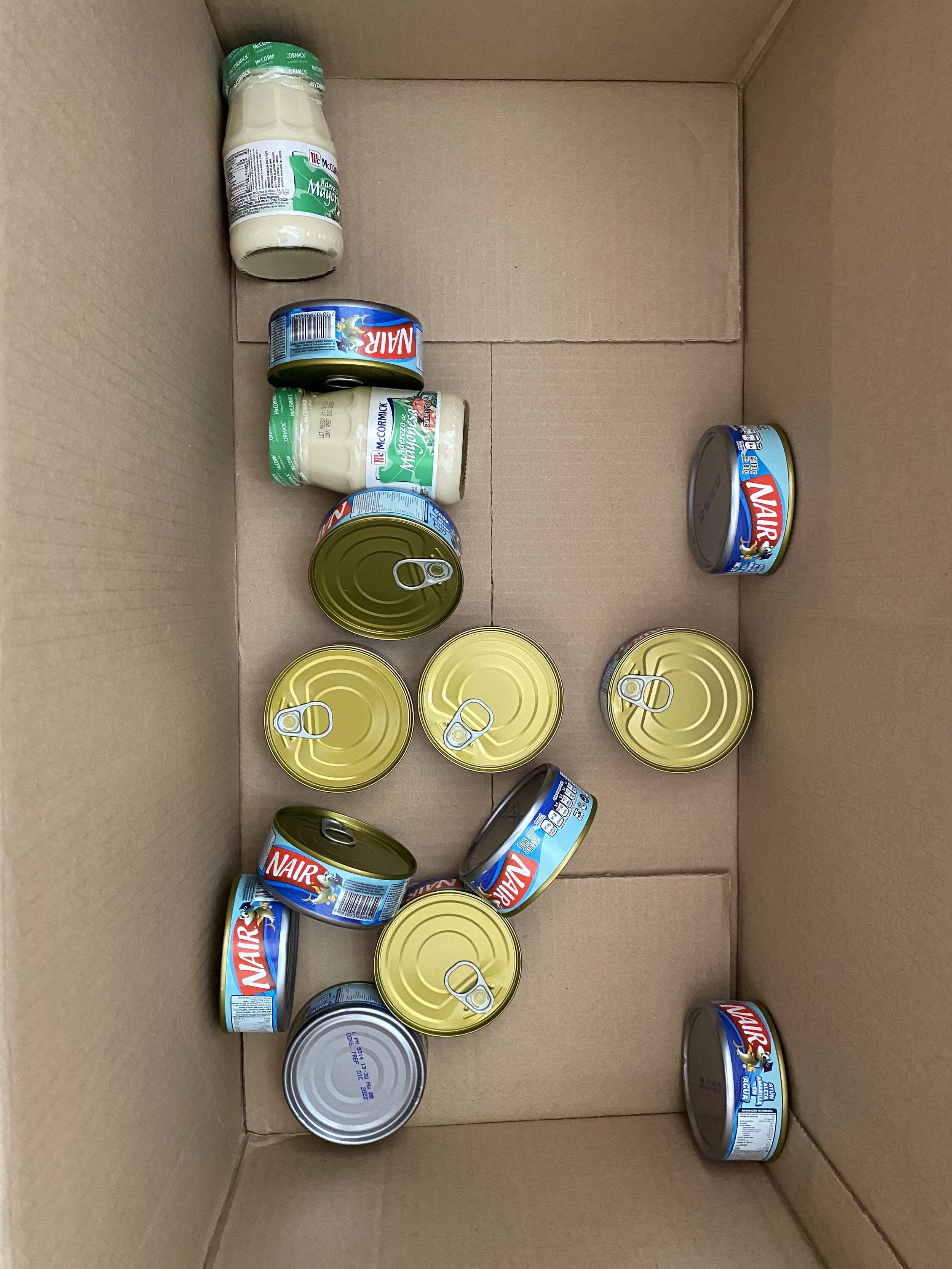  Lawson’s despensa also includes tuna and mayo. Here we are preparing the second boxes, one box per family.  There are two families, so everything is times two and we are taking these items every two weeks. In the village, it turns out that the recip