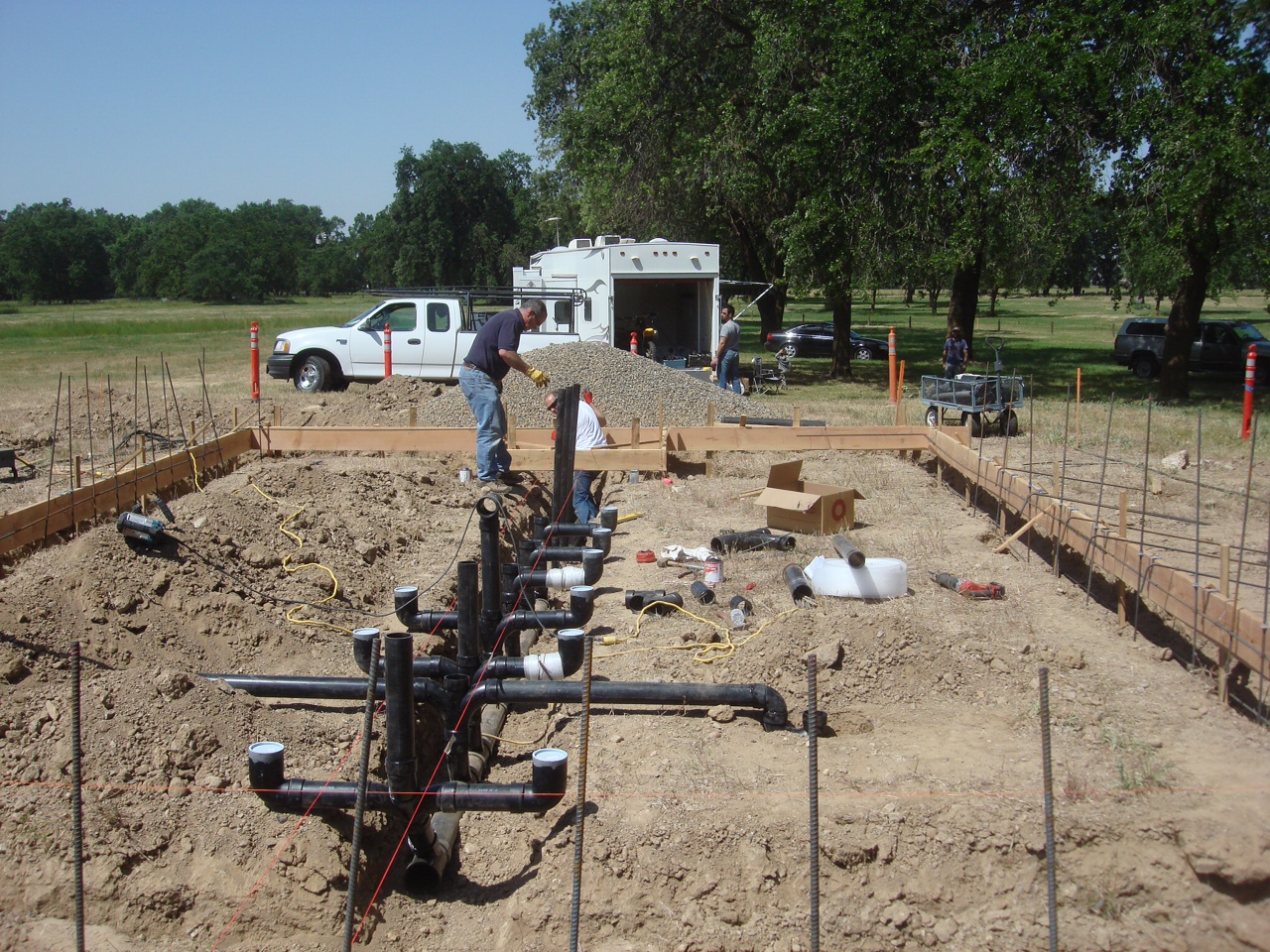 Sam Manolakas and John Gassoumis work on the plumbing for the Hellenic Park bathrooms.