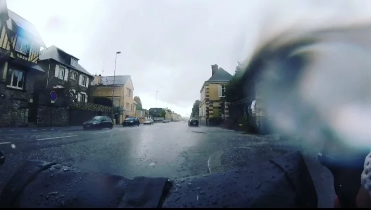 Rain and hail washing up over my handlebars at the Saint-Lô city limits.