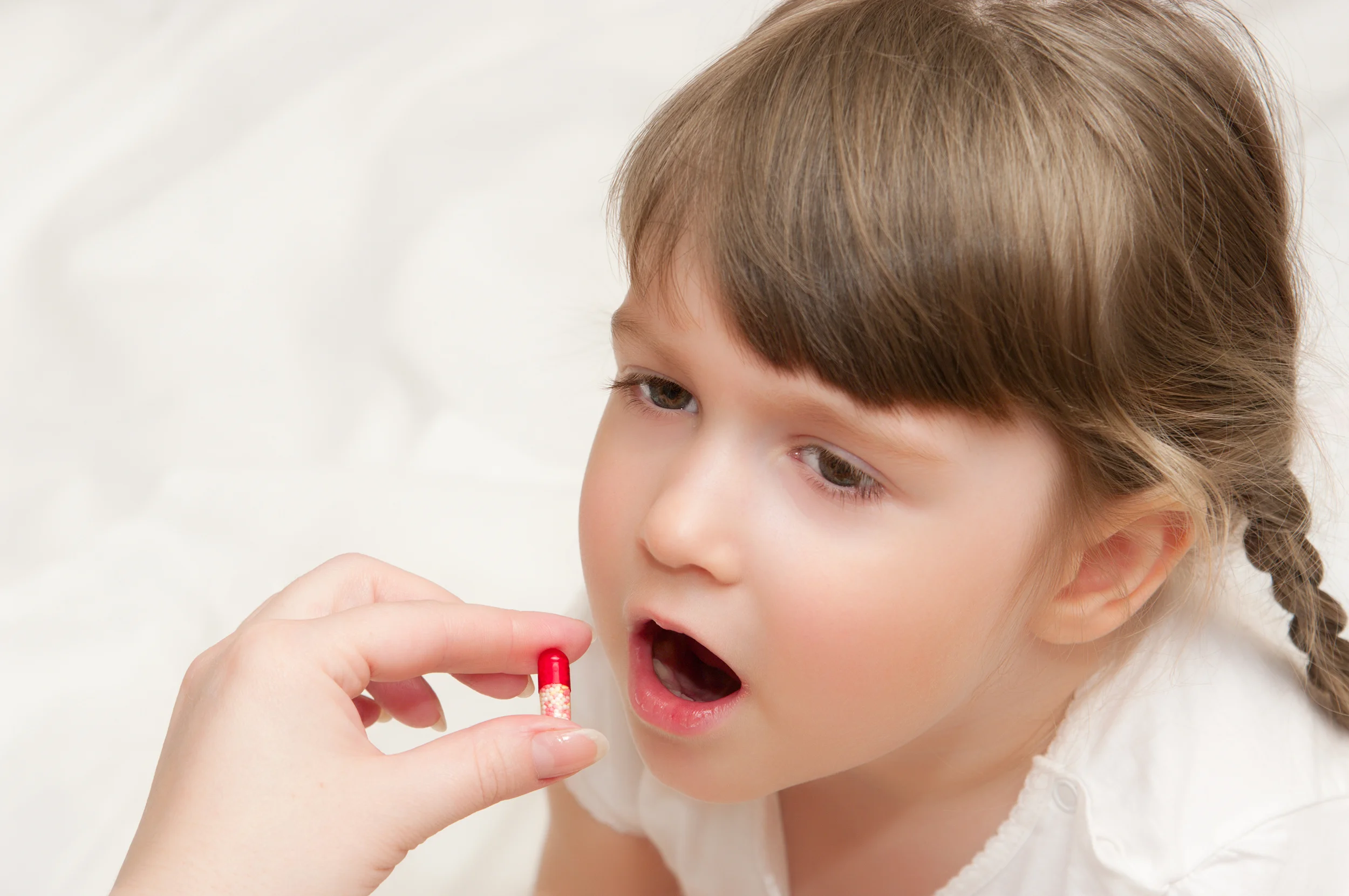 Woman Give Red Pill to Little Girl