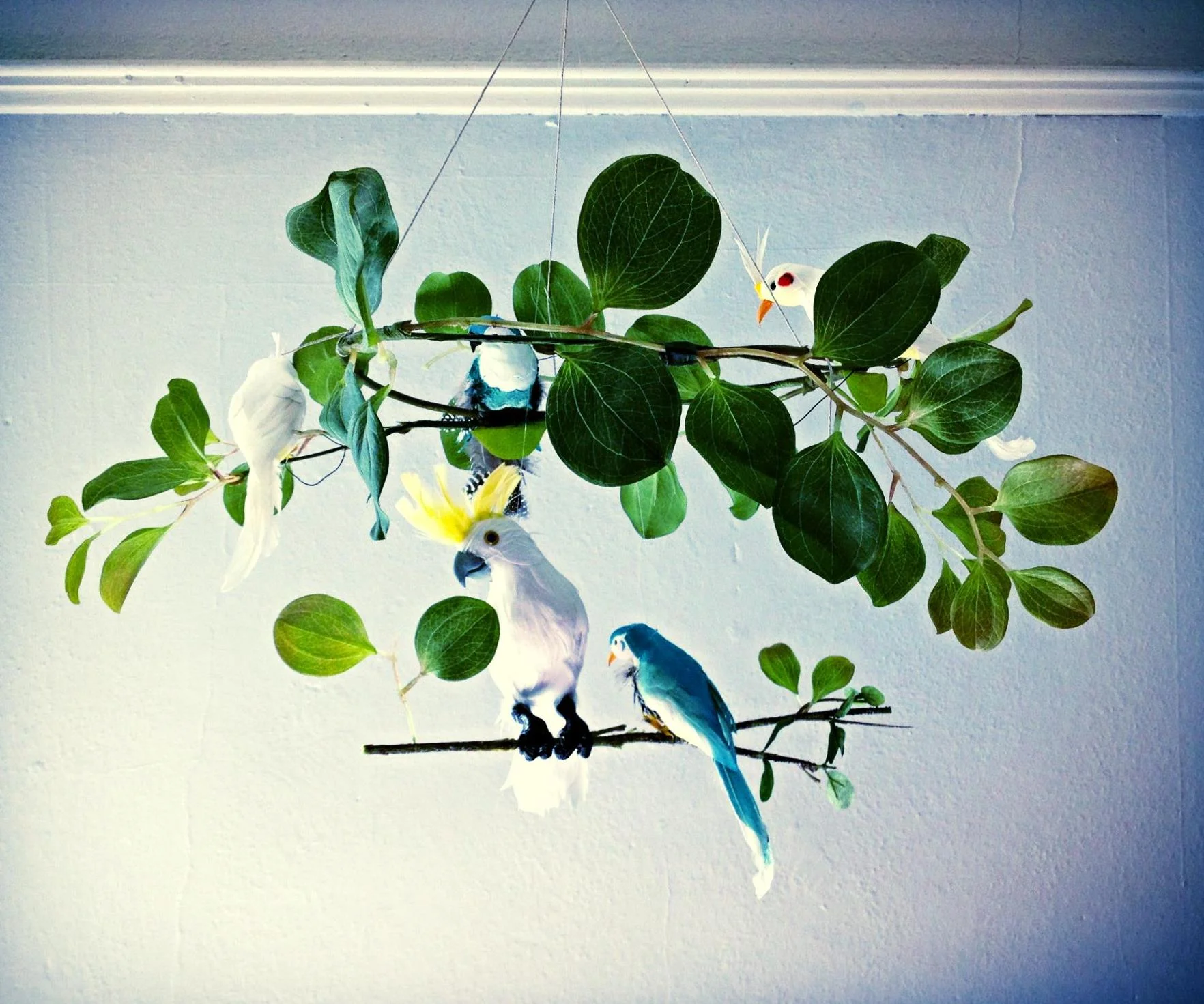 A jungle-themed baby mobile, handmade with vintage accents.