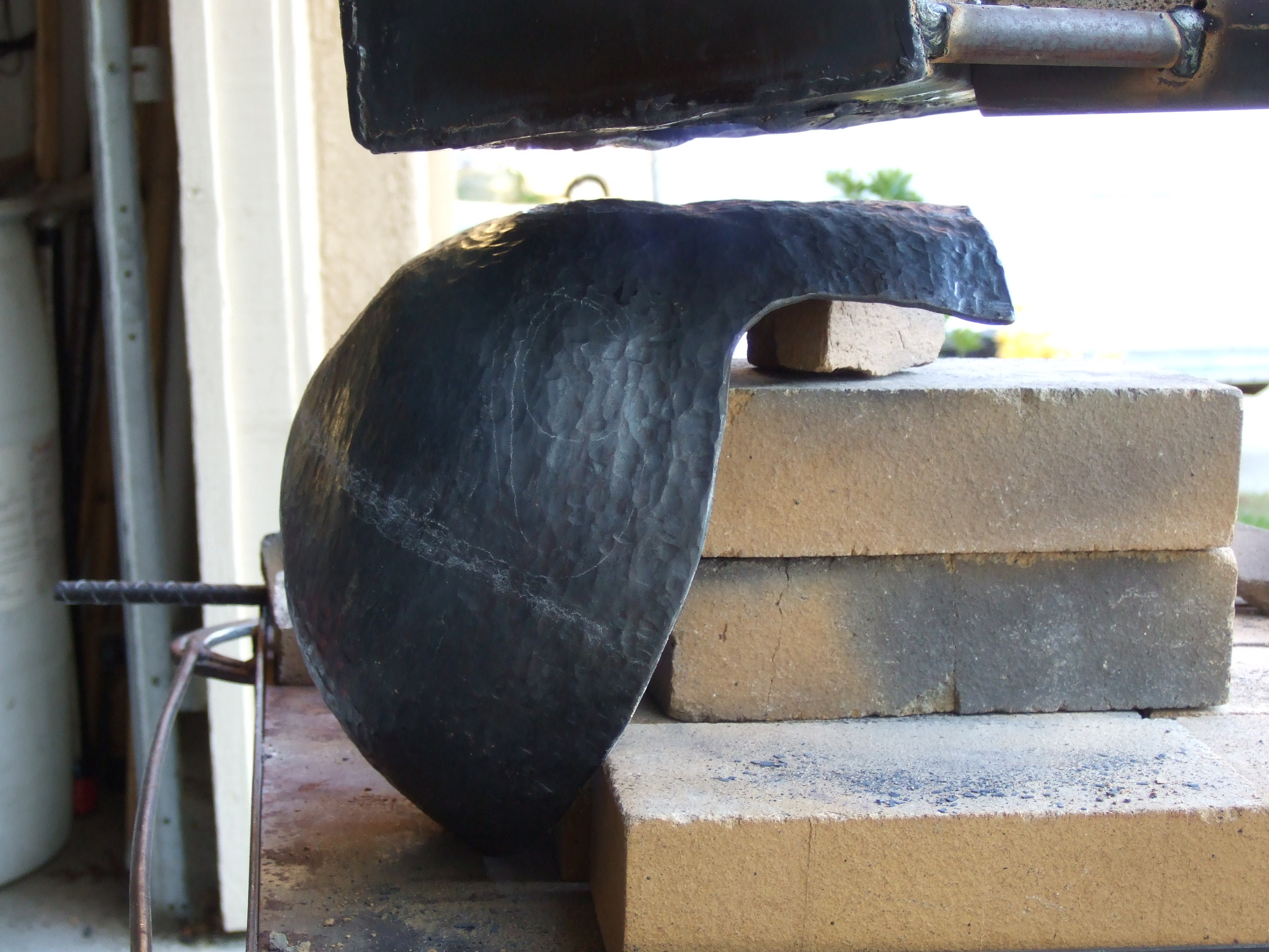 I was limited to working during the day, but working in direct sunlight is terrible for this kind of hot work. It's very difficult to see the colors of the steel and to know when to stop hammering, so I had to go off of what kind vibration, resistance, and sound the steel made.