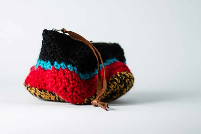   WOOL PURSE. You and your things should stay warm.&nbsp;Handcrochet wool &nbsp;purse with cotton lining. Chrome zipper with leather strap.  