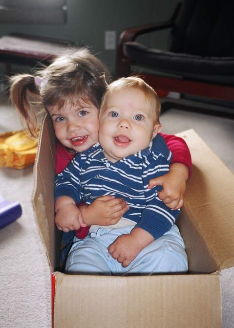 Ana and Sam in a cardboard box