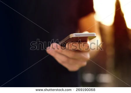 stock-photo-man-using-mobile-smartphone-focus-on-top-of-the-phone-269190068.jpg