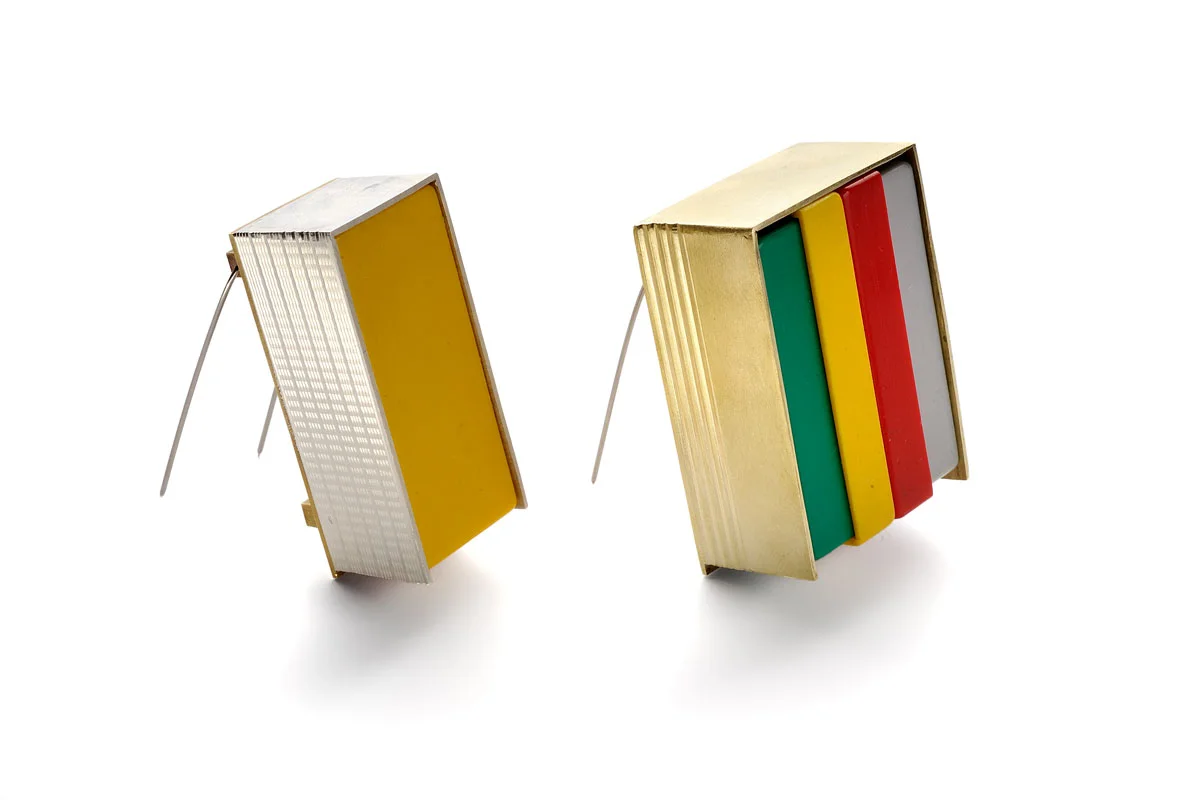 Brooches On the left: Sterling silver, brass, steel, plastic box. On the right: Brass, plastic boxes, steel. 