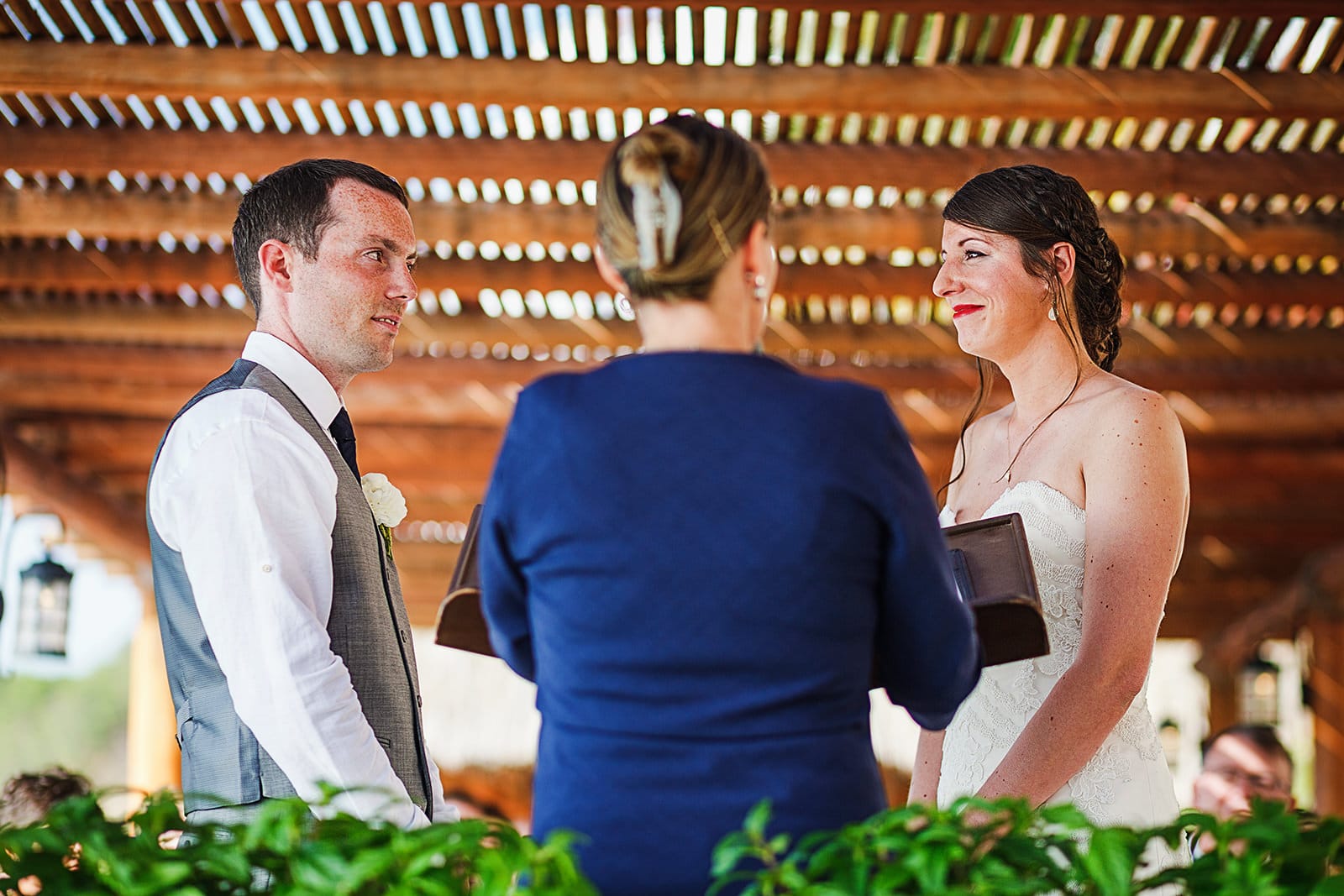 Bride and groom stare at each other during wedding ceremony at Playa Fiesta terrace