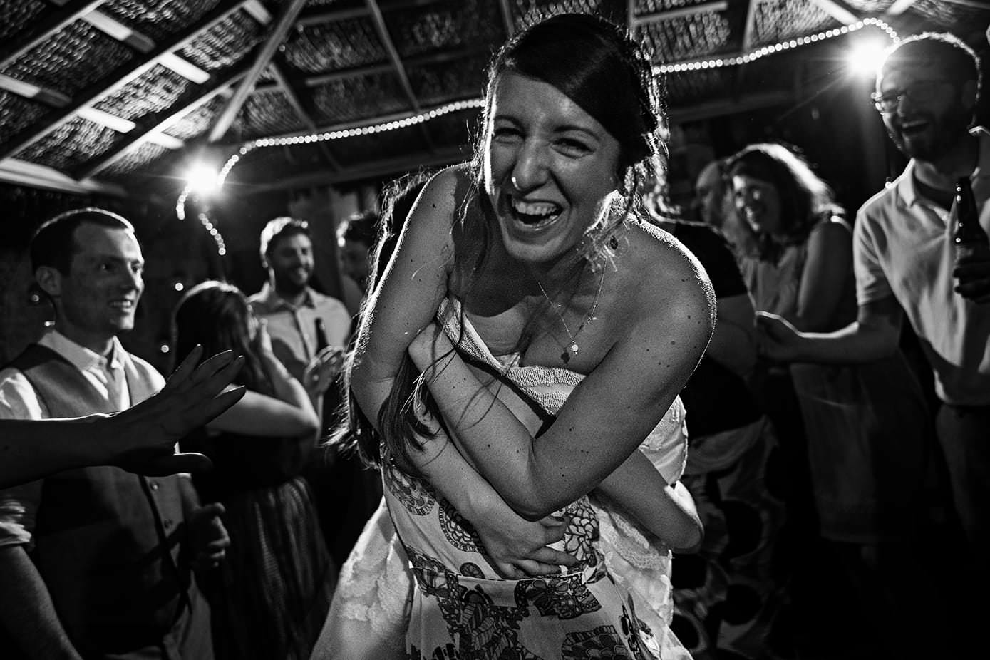 A girl friend of the bride pick her up in the middle of the dance floor at reception held in Playa Fiesta Mexico