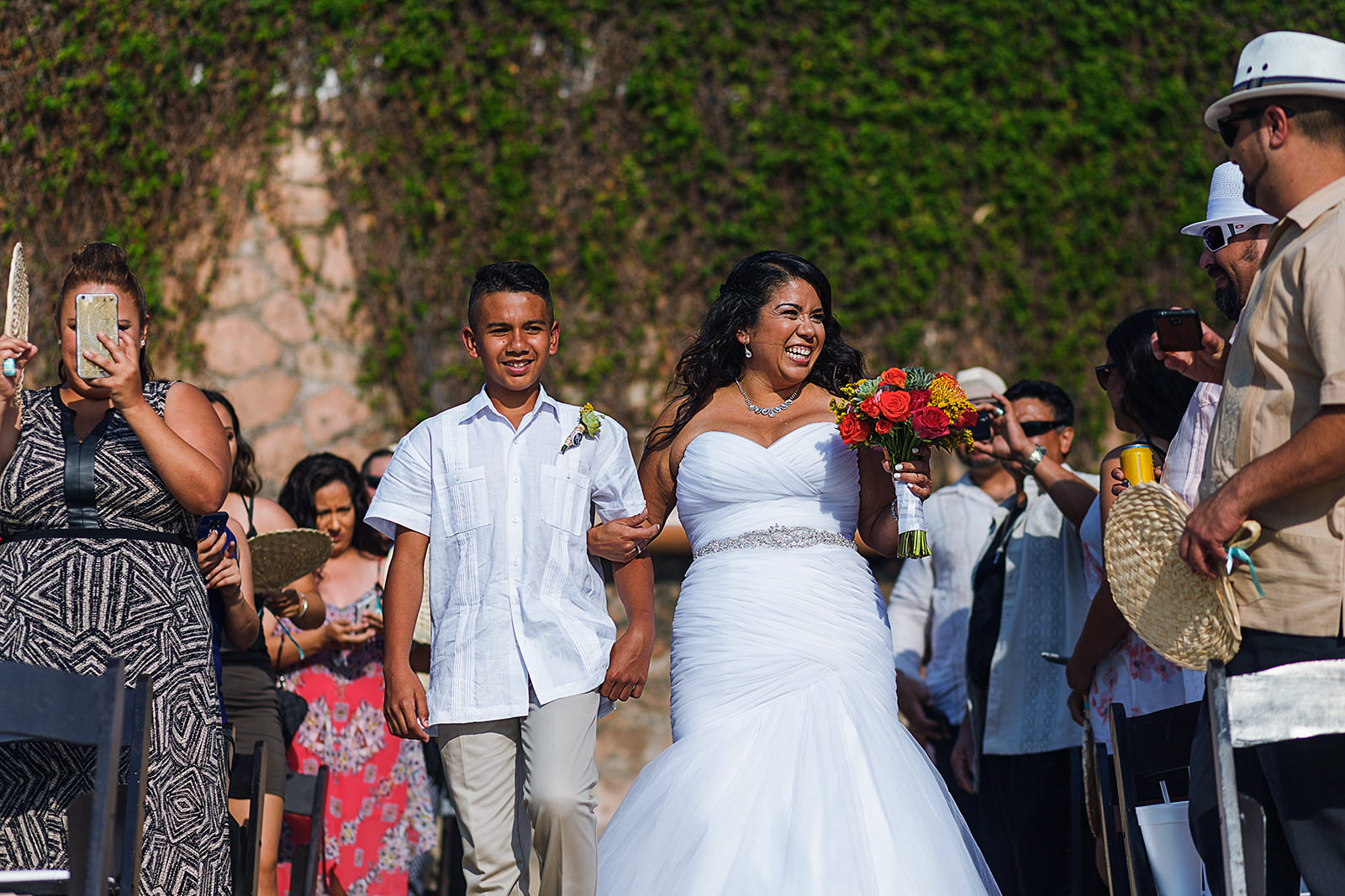 Bride and son walking down the aisle for wedding ceremony