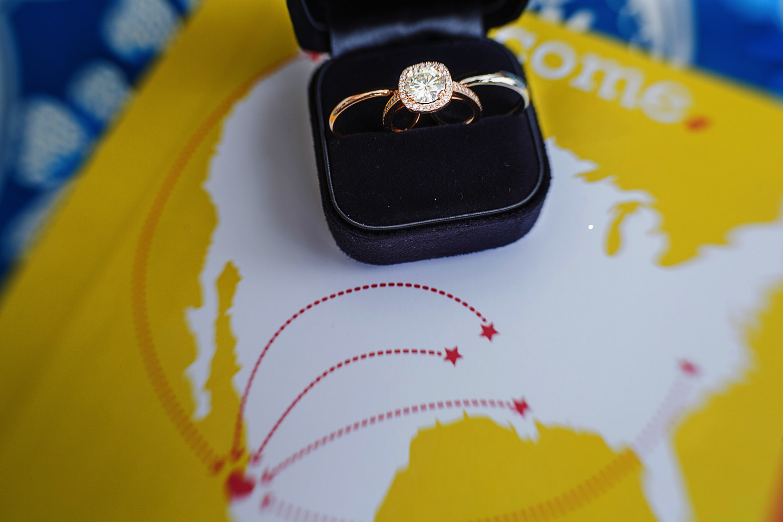 wedding ring and wedding bands on case on top of wedding booklet