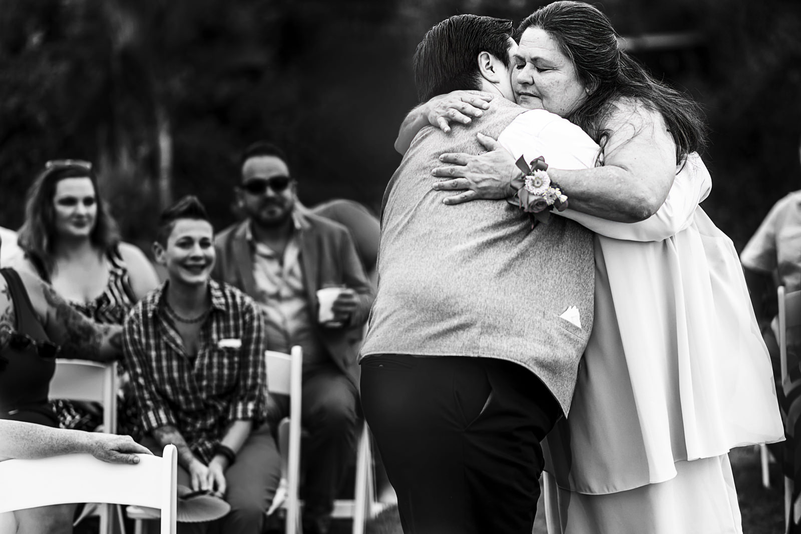 Bride and mother hugging at the end of the aisle before wedding ceremony