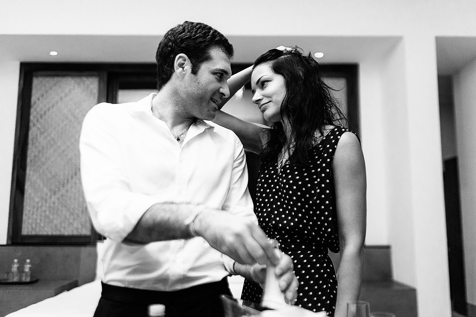 Couple opening bottle of champagne