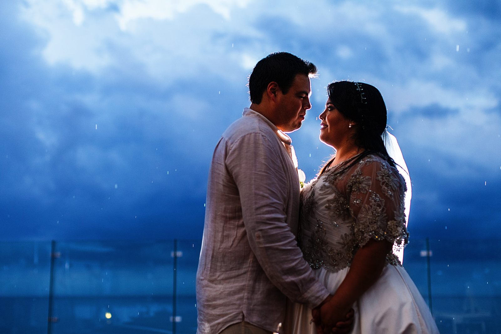 Couple standing on the rain backlight with flash - Iberostar Mexico