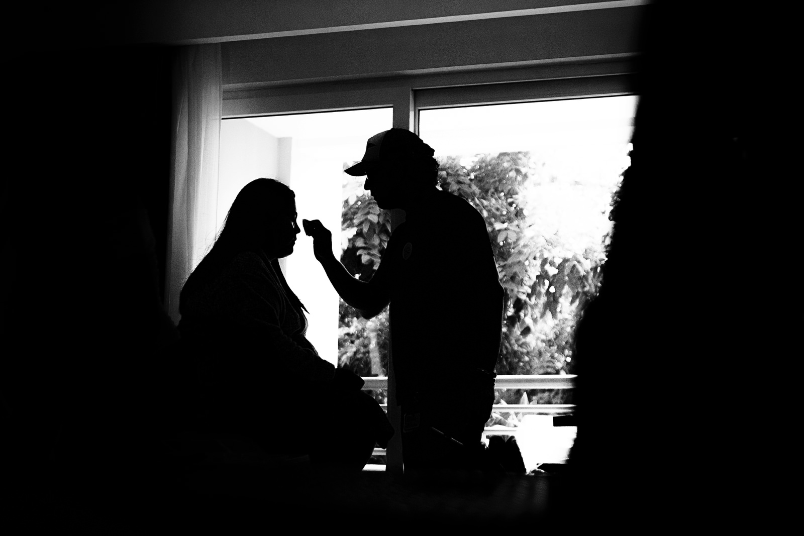 Silhouette of the bride getting her make up before the ceremony