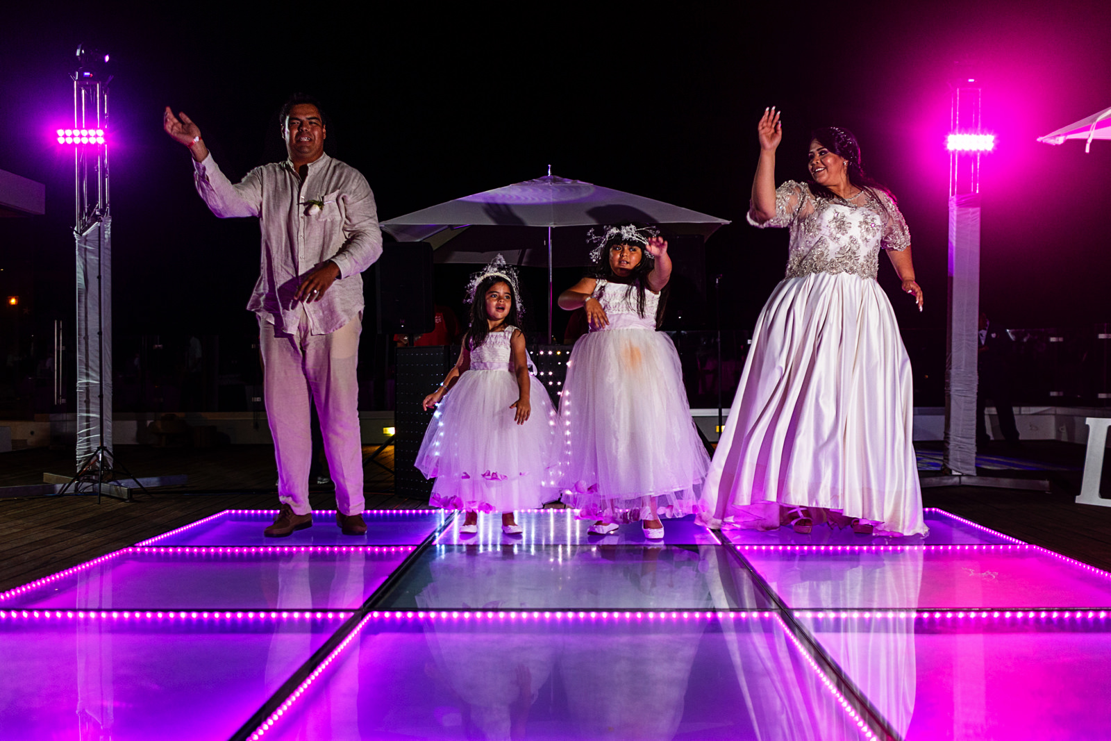 Bride, groom and daughters (flower girls) doing a dance for the guests as part of the first dance