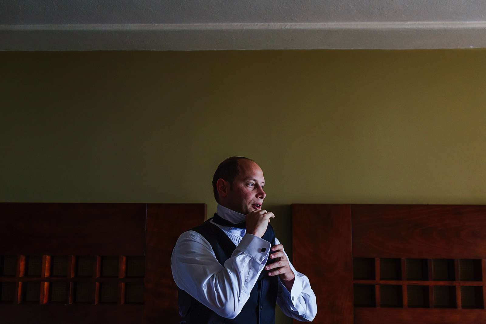 Groom putting on his tie
