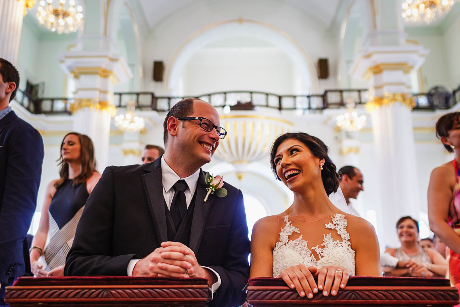 Groom and bride laugh during ceremony at Lady of Guadalupe church, downtown Puerto Vallarta, Mexico