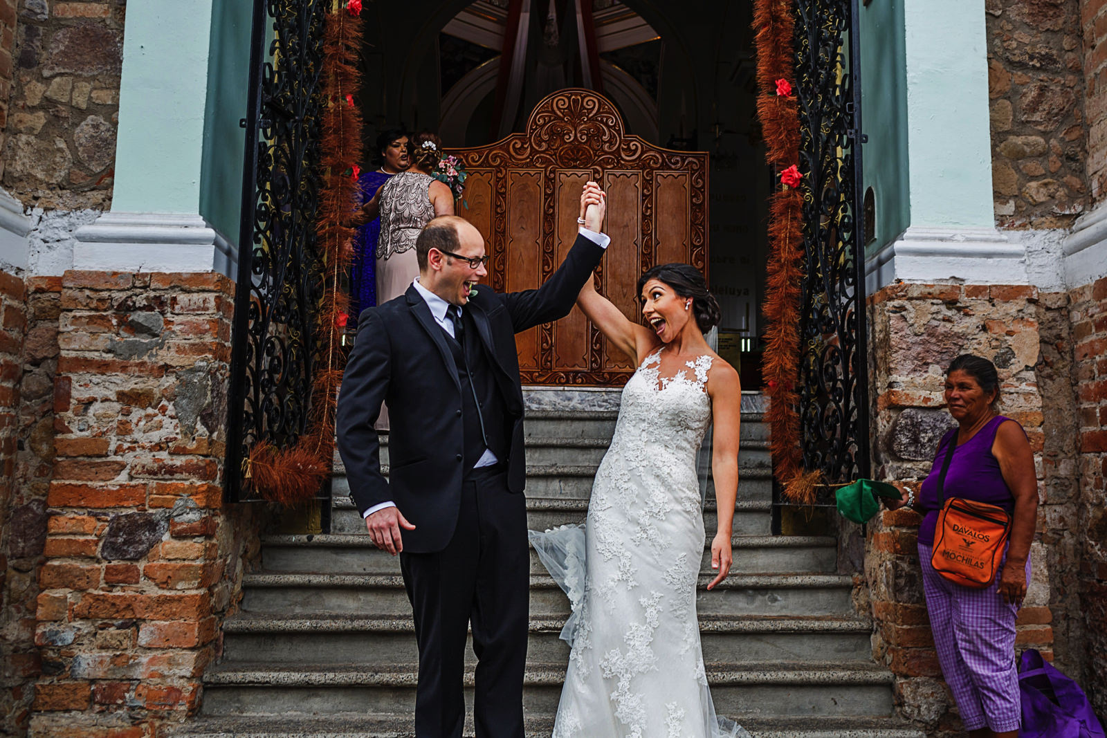 Groom and bride celebrate after wedding ceremony outside Lady of Guadalupe church, downtown Puerto Vallarta, Mexico