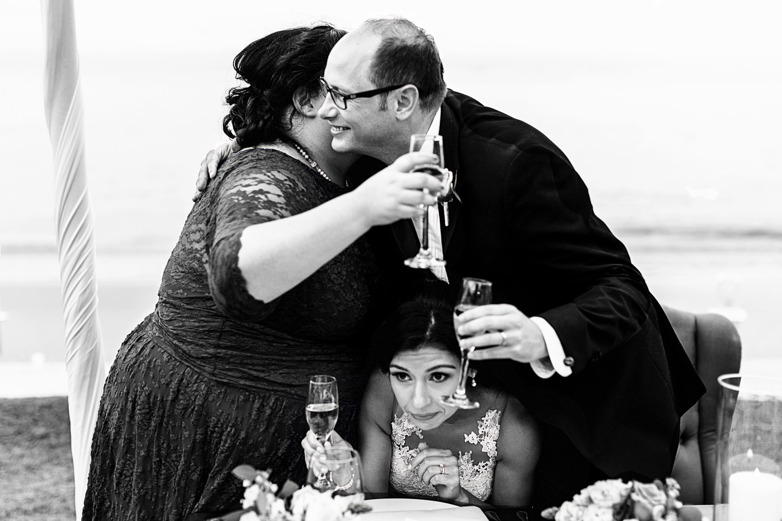 Maid of honor and groom hug after speech and squish bride between them - Fearless award