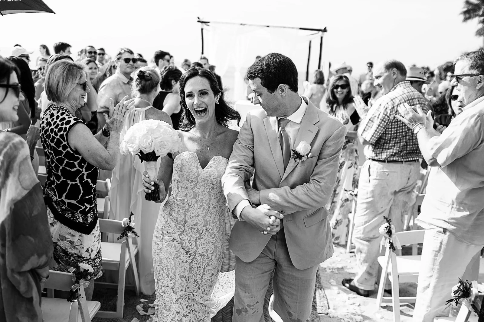 Couple exit from wedding ceremony on the beach - Eder Acevedo cancun los cabos vallarta wedding photographer